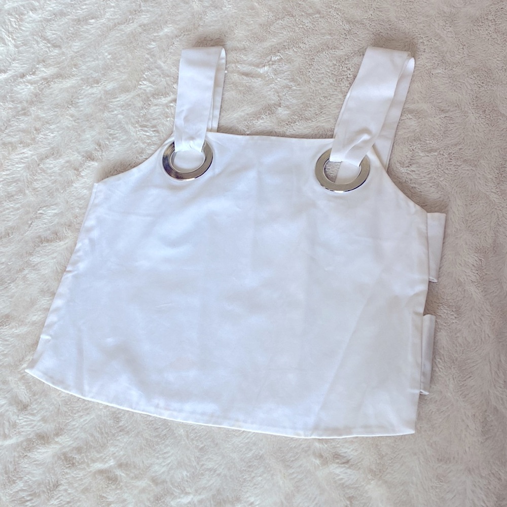 Cropped white tank with cut out sides and strap embellishment